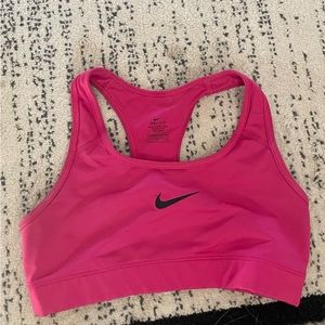 Bright pink Nike sports bra.